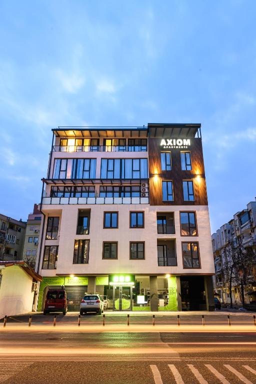 a building with a sign on the side of it at AXIOM Apartments - city center in Skopje