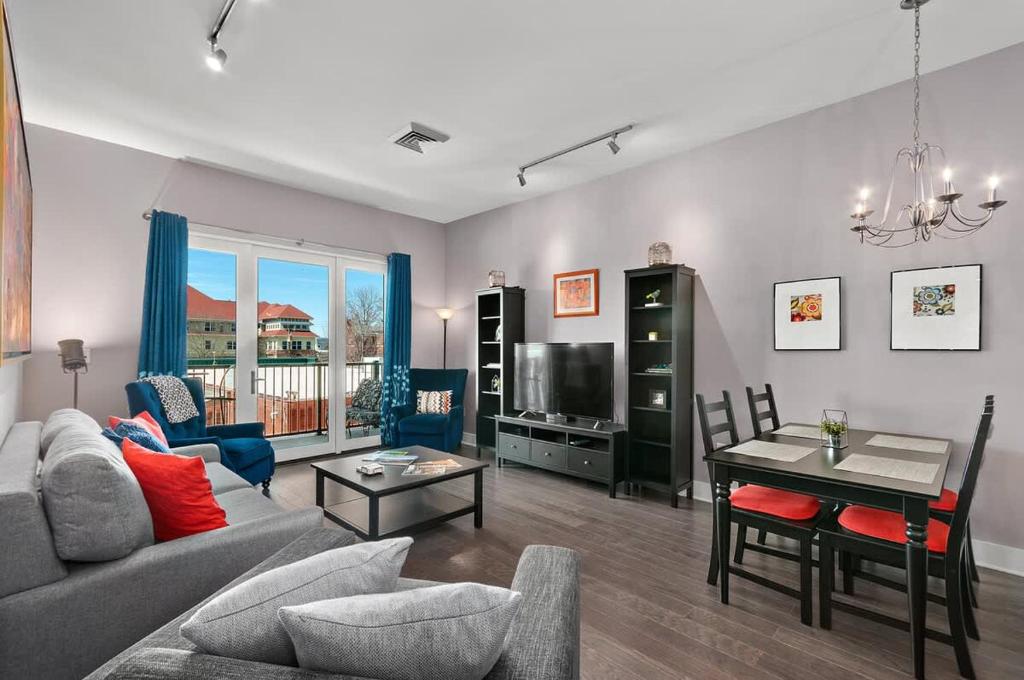 a living room with a couch and a table at 2BR Condo with Balcony, Free Tix, Walk to Downtown in Asheville