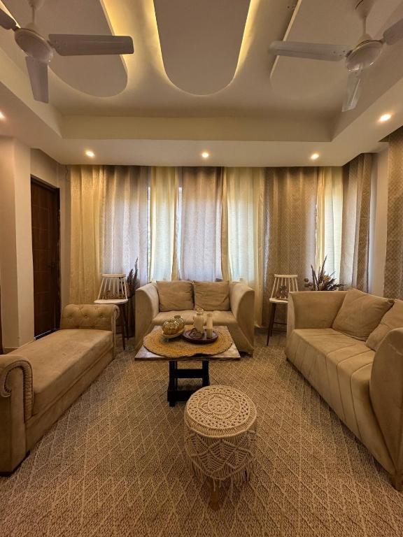 a living room with two couches and a table at Shelbys Abode in Dehradun