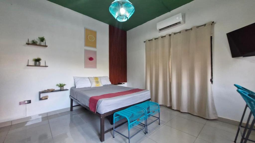 a bedroom with a bed and a television in it at 5 Beach Suite wpool sea access in La Libertad