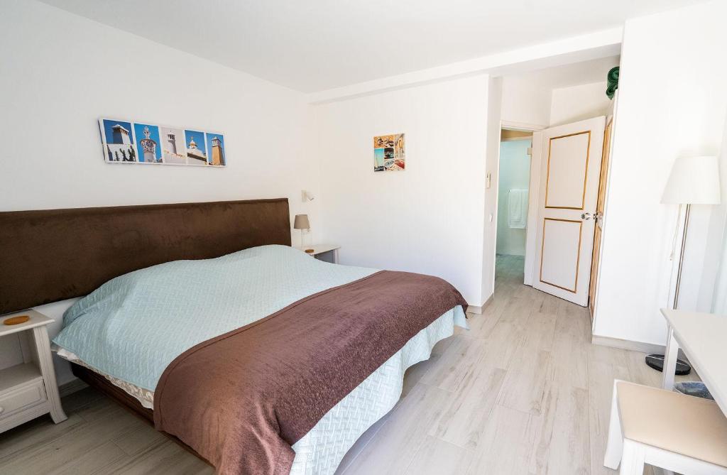 Postel nebo postele na pokoji v ubytování Luz Beach Apartments