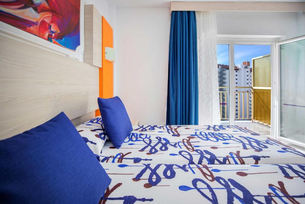 Postel nebo postele na pokoji v ubytování Hotel Servigroup Orange