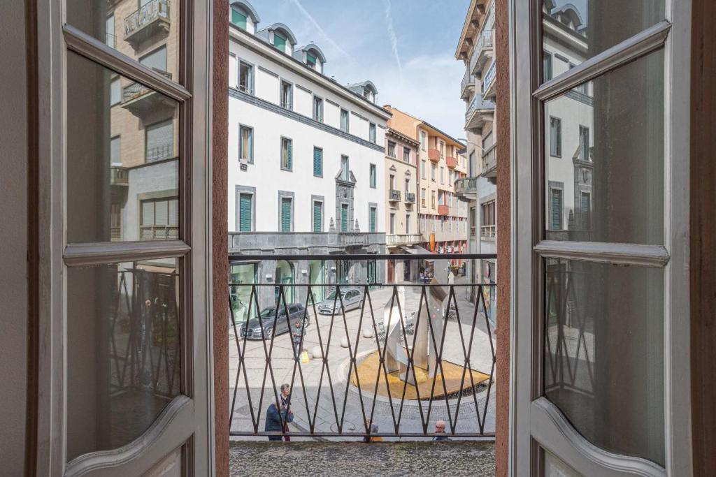 an open window with a view of a city street at Studio Caspani - Duomo Centro Storico in Como