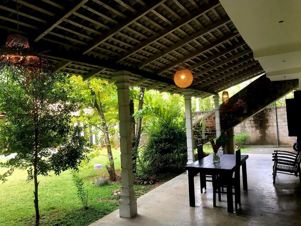 a pergola with a table on a patio at Kadol Villa in Unawatuna
