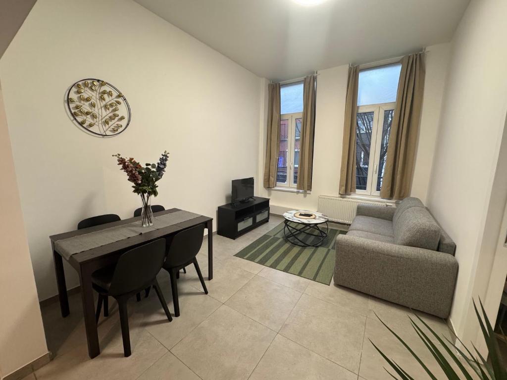 a living room with a table and a couch at Apartment Close to Zuid Park in Antwerp
