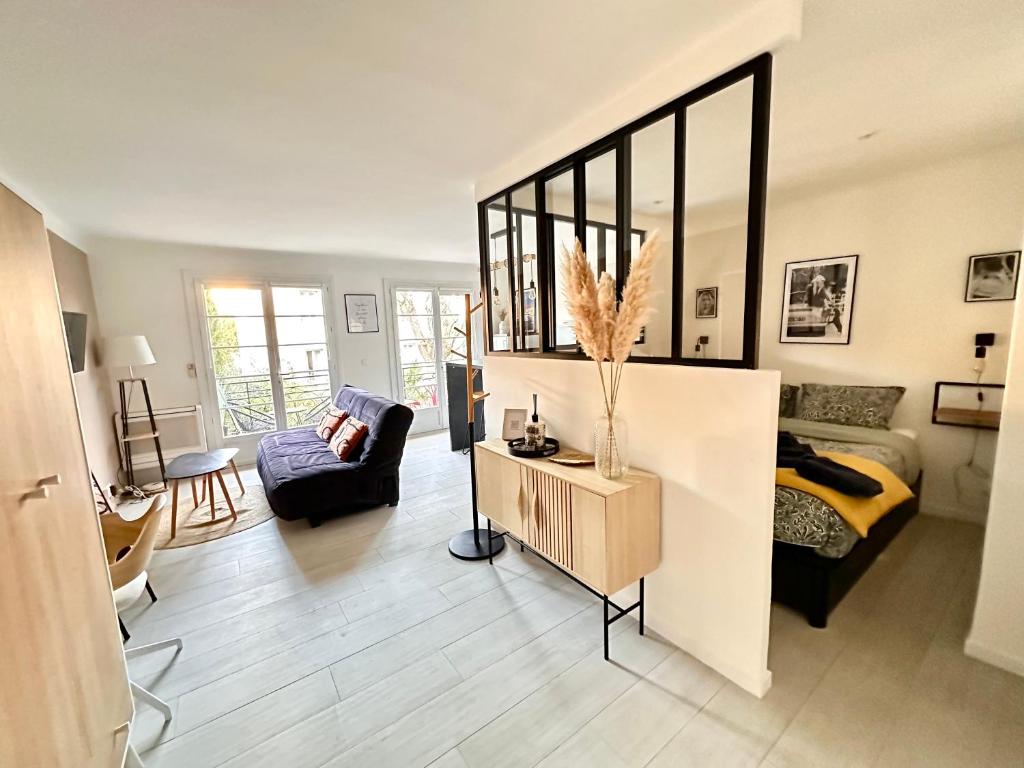 a large living room with a bed and a couch at Chez Garance Saint-Tropez in Saint-Tropez