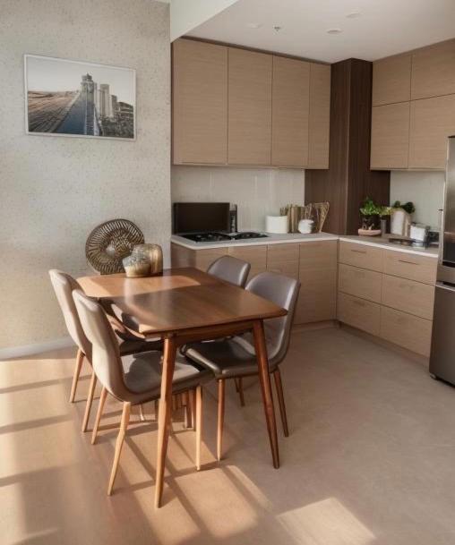 a kitchen with a wooden dining table and chairs at Comfortable Zone in Klong Toi