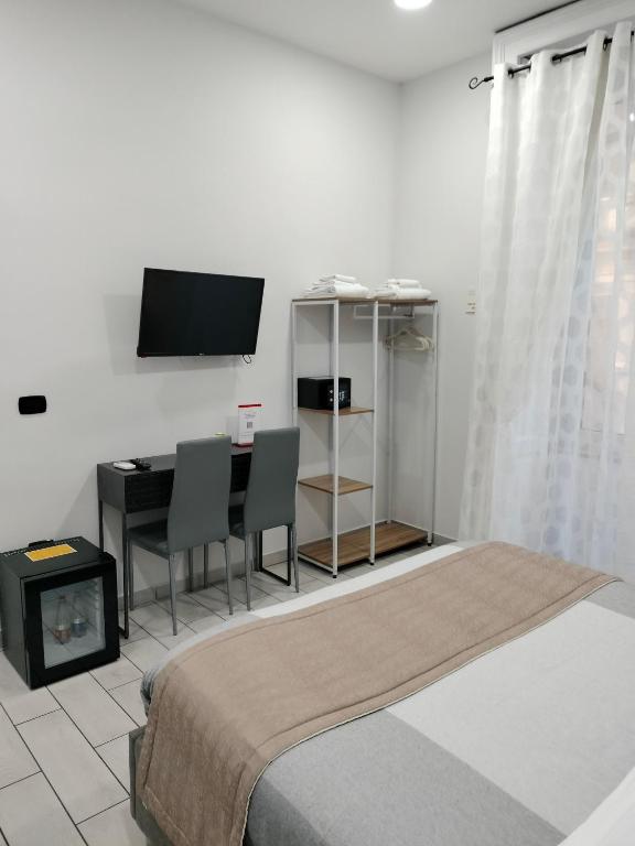 Televízia a/alebo spoločenská miestnosť v ubytovaní B&B Marcello&Core