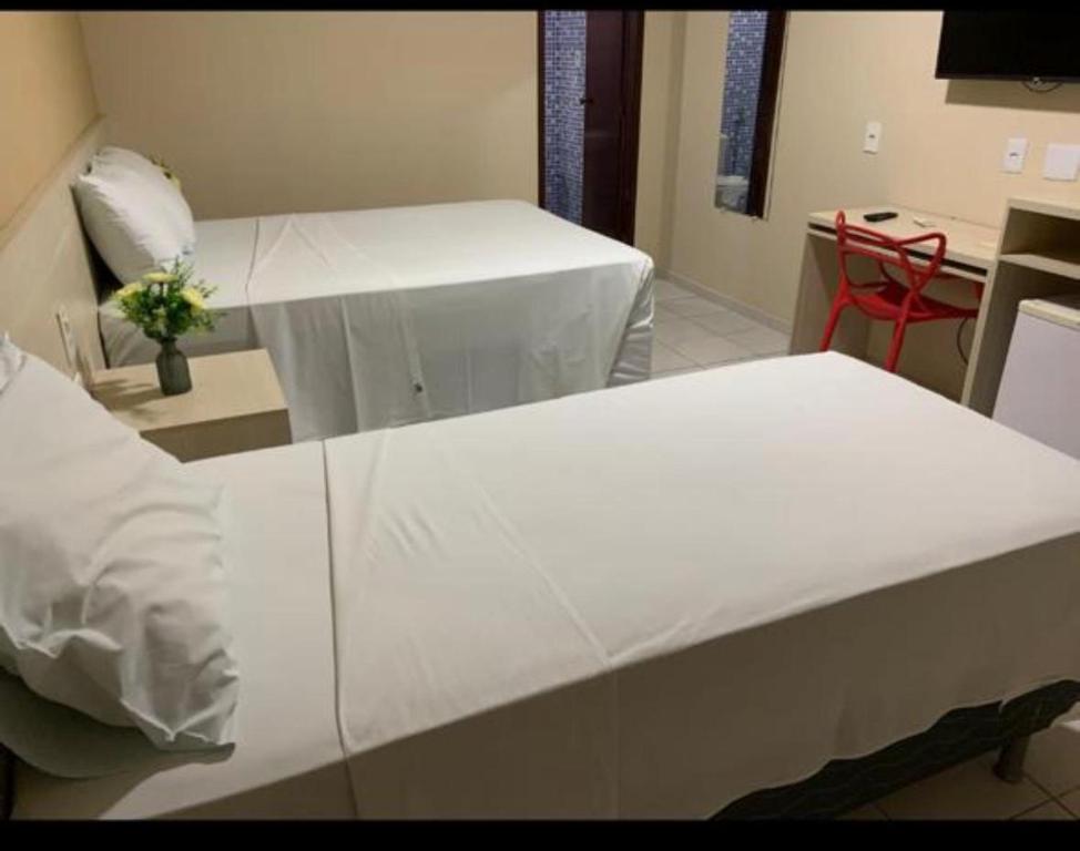 Postel nebo postele na pokoji v ubytování Hotel Sambaquis
