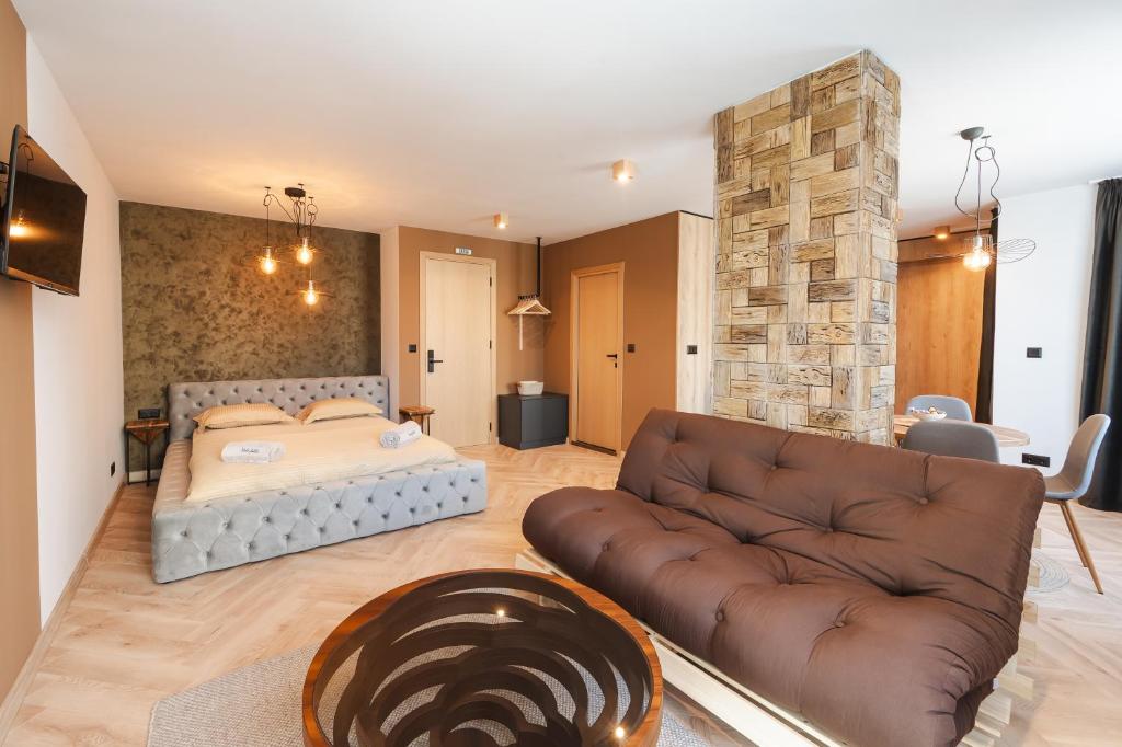 a living room with a bed and a couch at Уютно Студио Verde Suites 07 in Blagoevgrad