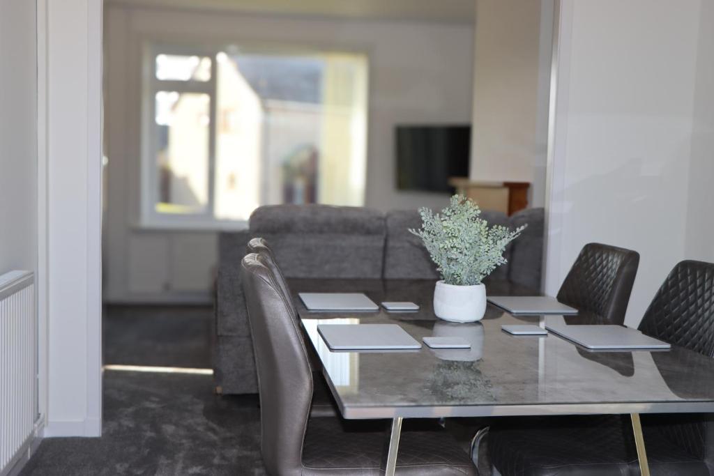 a dining room table with chairs and a couch at Luxury 3 bed home in central Thurso - NC500 in Thurso