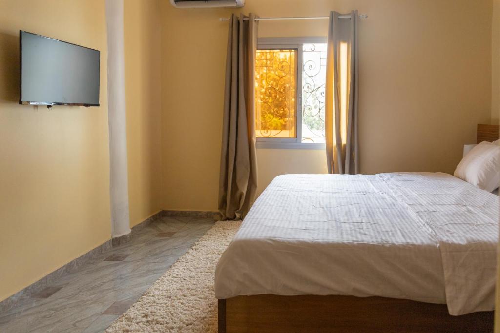 Postel nebo postele na pokoji v ubytování High-end 2BR apartment in the heart of Yaoundé