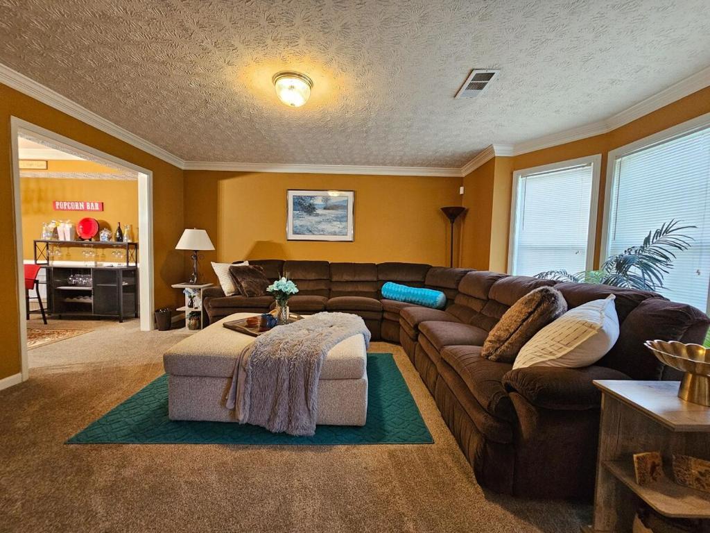 a living room with a couch and a table at Friends & Family Suburban Retreat in Stone Mountain