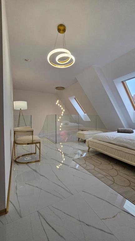 a bedroom with a bed and a chandelier at Cinema Galaxy Apartment in Słupsk