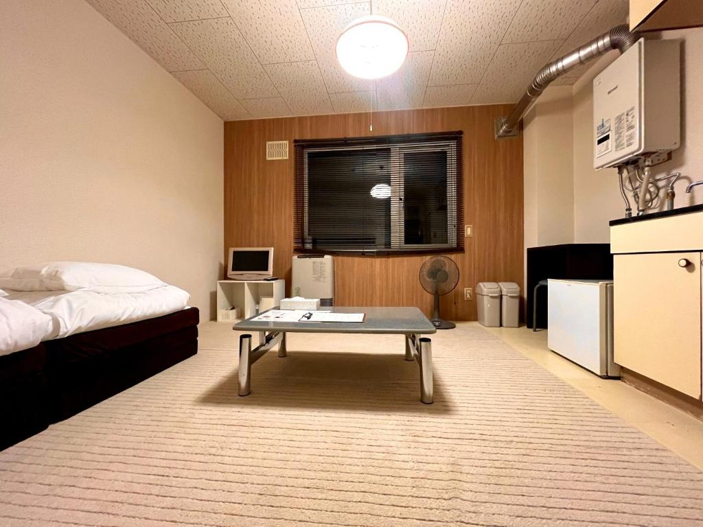 a room with a bed and a coffee table in it at Maison Loire - Vacation STAY 18226 in Hakodate