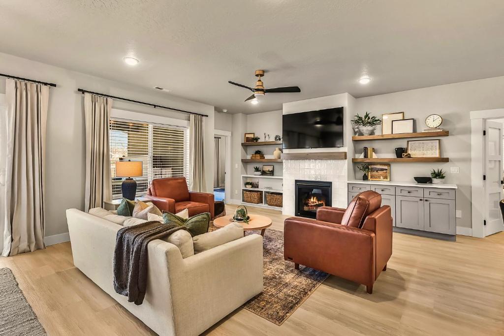 a living room with a couch and chairs and a fireplace at Luxury 4br Mineral Spa, Game Room, Fire Pit Fun in Meridian