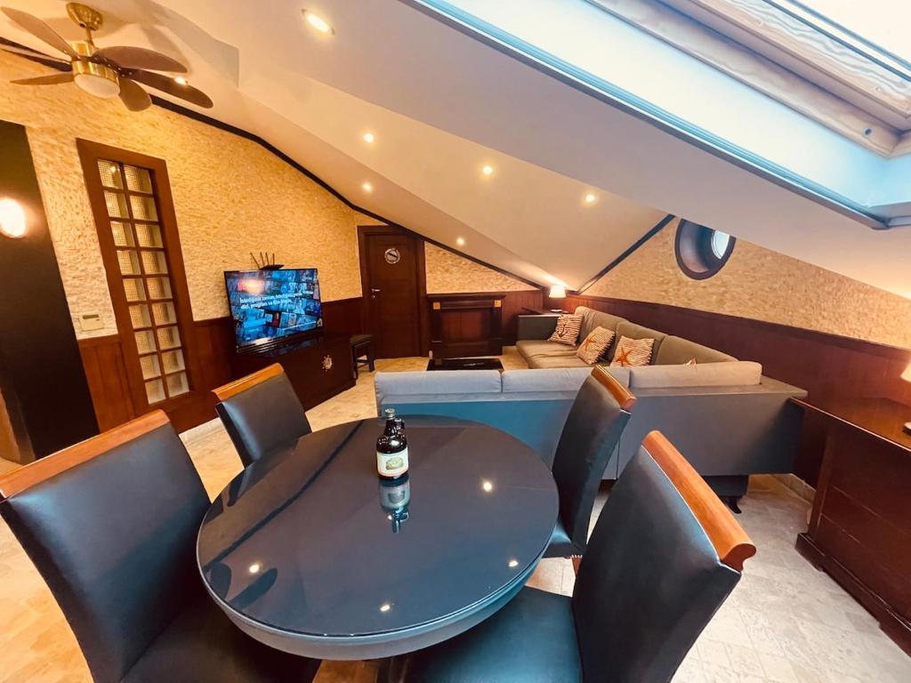 a living room with a table and chairs and a couch at Retro, two bedroom and livingroom on Main Street in Çekmeköy