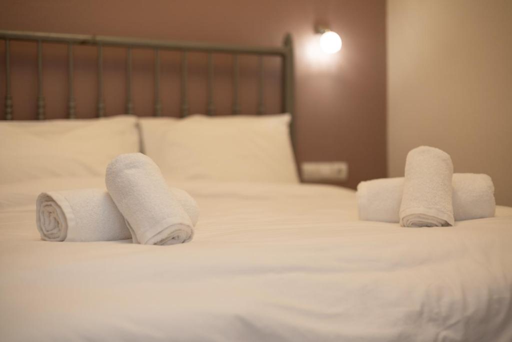 a bed with three rolled up towels on it at Sweet suite in Kalabaka