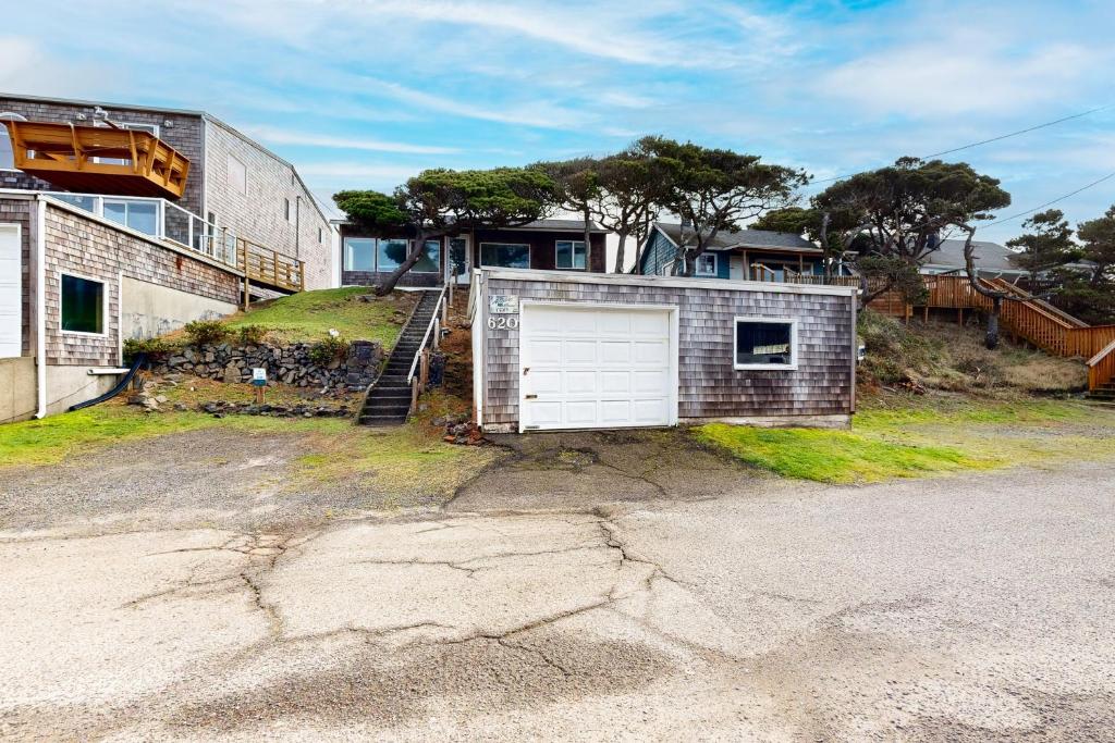 a garage with a door on the side of a house at Auntie's House in Rockaway Beach