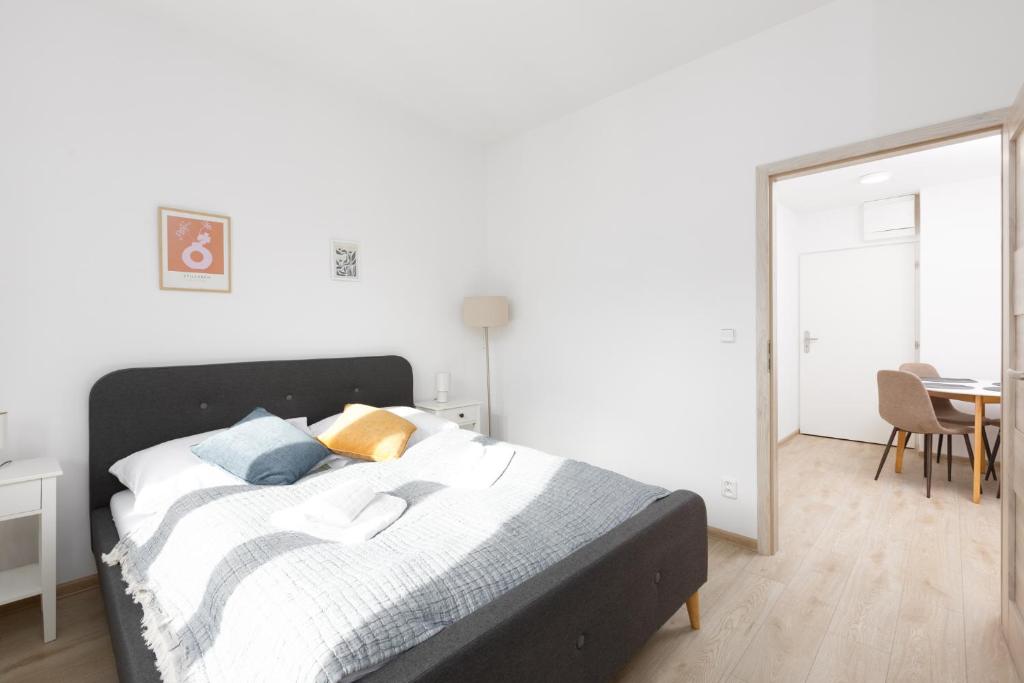 a bedroom with a bed and a table and a mirror at 2 bedroom apartment with a terrace near the metro in Prague