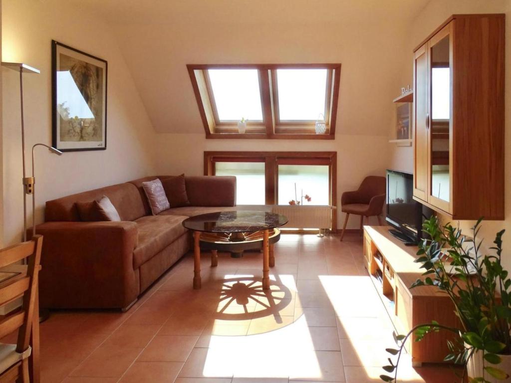 a living room with a couch and a table at Apartment for up to 7 people in Lepels Hof in Lütow