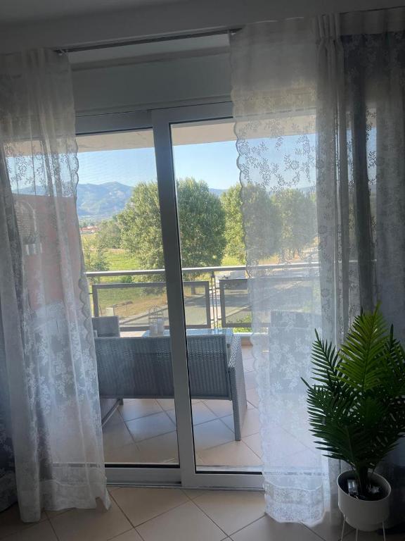 a room with a window with a view of a patio at Lovely apartment cosmopoli in Komotini