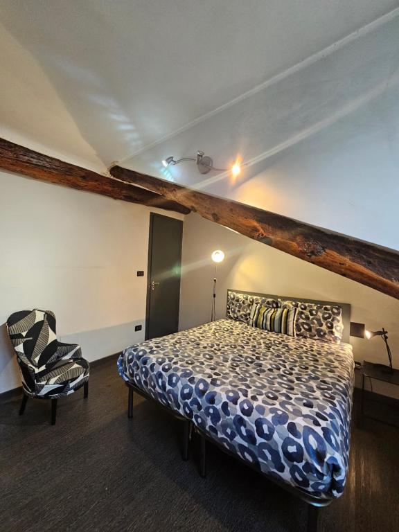 a bedroom with a bed and a chair at City Center Heart in Turin