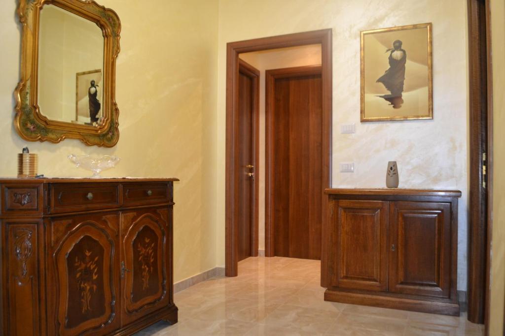 a bathroom with a wooden dresser and a mirror at B&B Visconti in Lido di Ostia