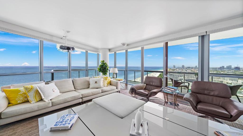 a living room with a couch and chairs at Oceanfront Private Penthouse Condo at The Setai -3909 in Miami Beach