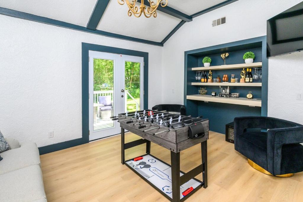 a living room with a table with a game at Hueytown Haven nearby Alabama Splash Adventure in Bessemer
