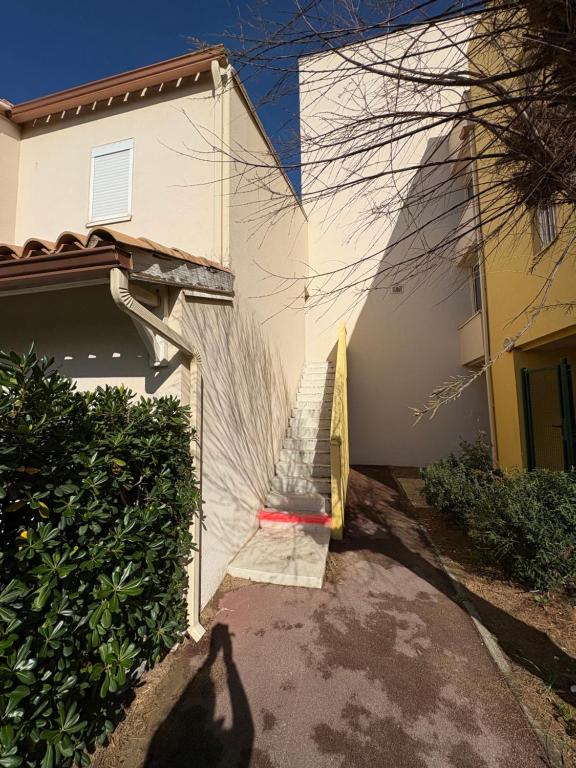 a shadow of a person standing next to a building at Chez Pierre in Narbonne