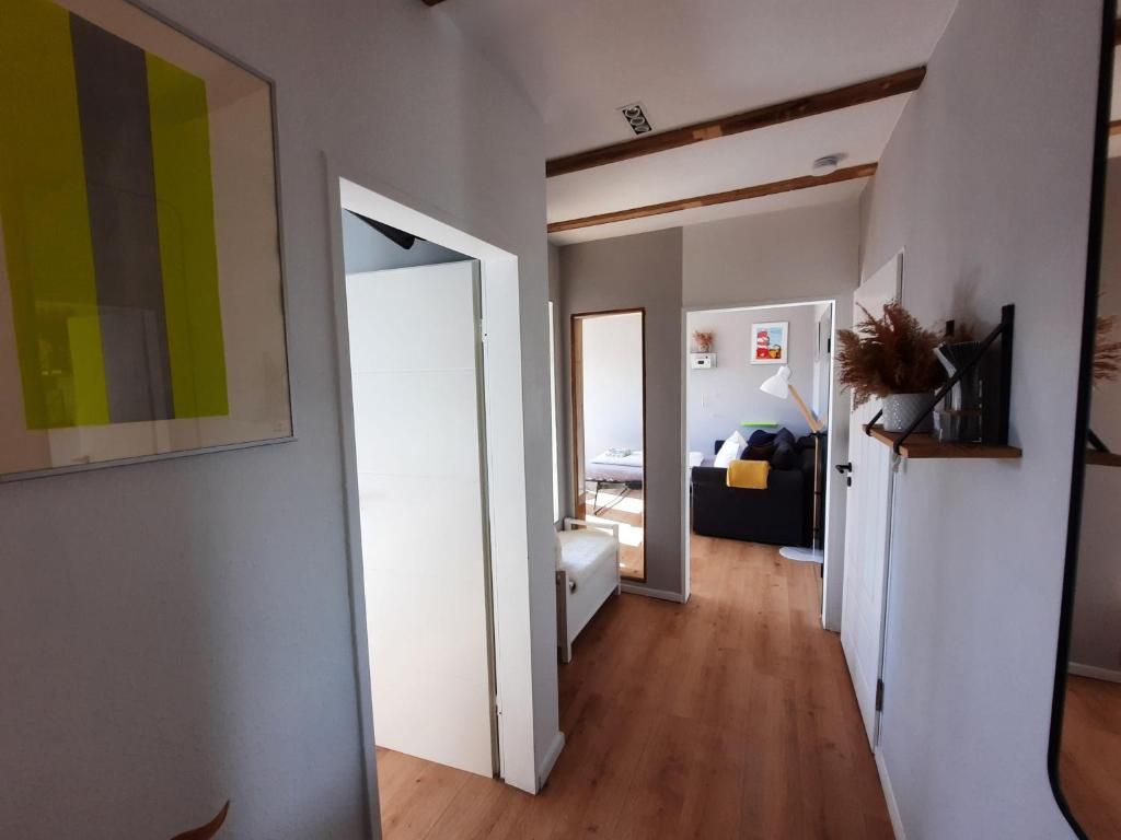 a hallway with an open door to a room at Moewennest-by-DeJu-Norderney in Norderney