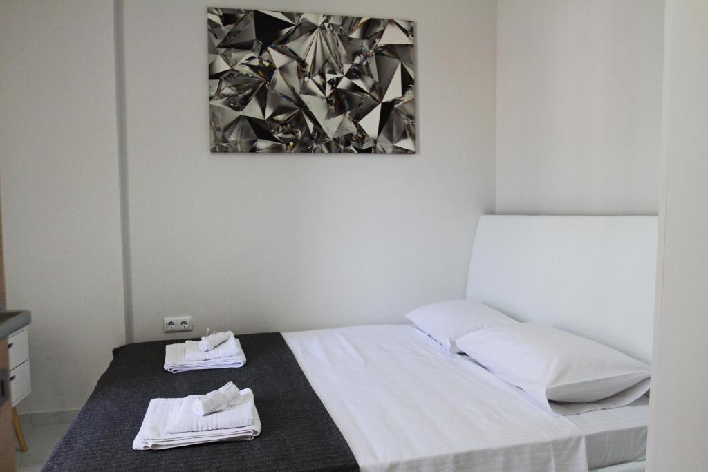 a bedroom with a bed with two towels on it at Kavala center in Kavala