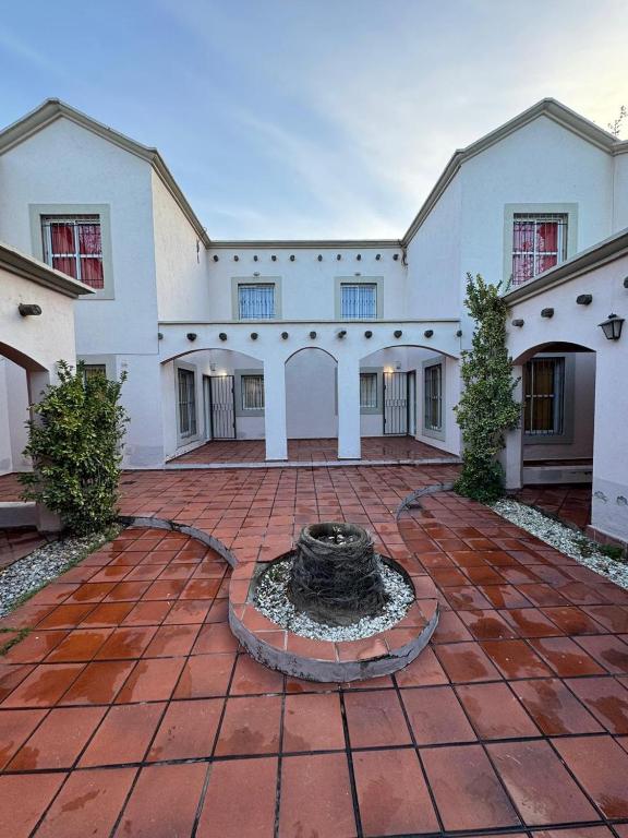 a building with a fountain in the middle of a courtyard at Duplex Aconcagua in Guaymallen