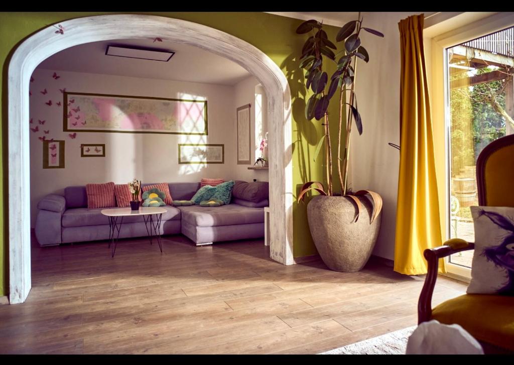 a living room with a couch and a table at Schöne Gartenwohnung in Salzburg