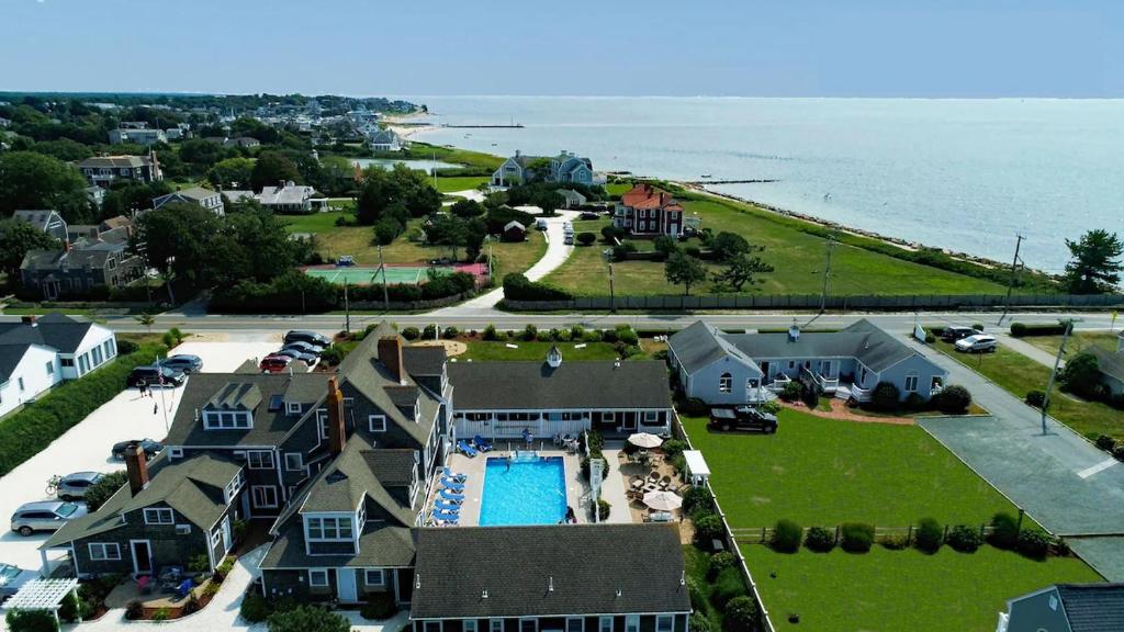 an aerial view of a house with a pool and the ocean at Beach Breeze Inn in Falmouth