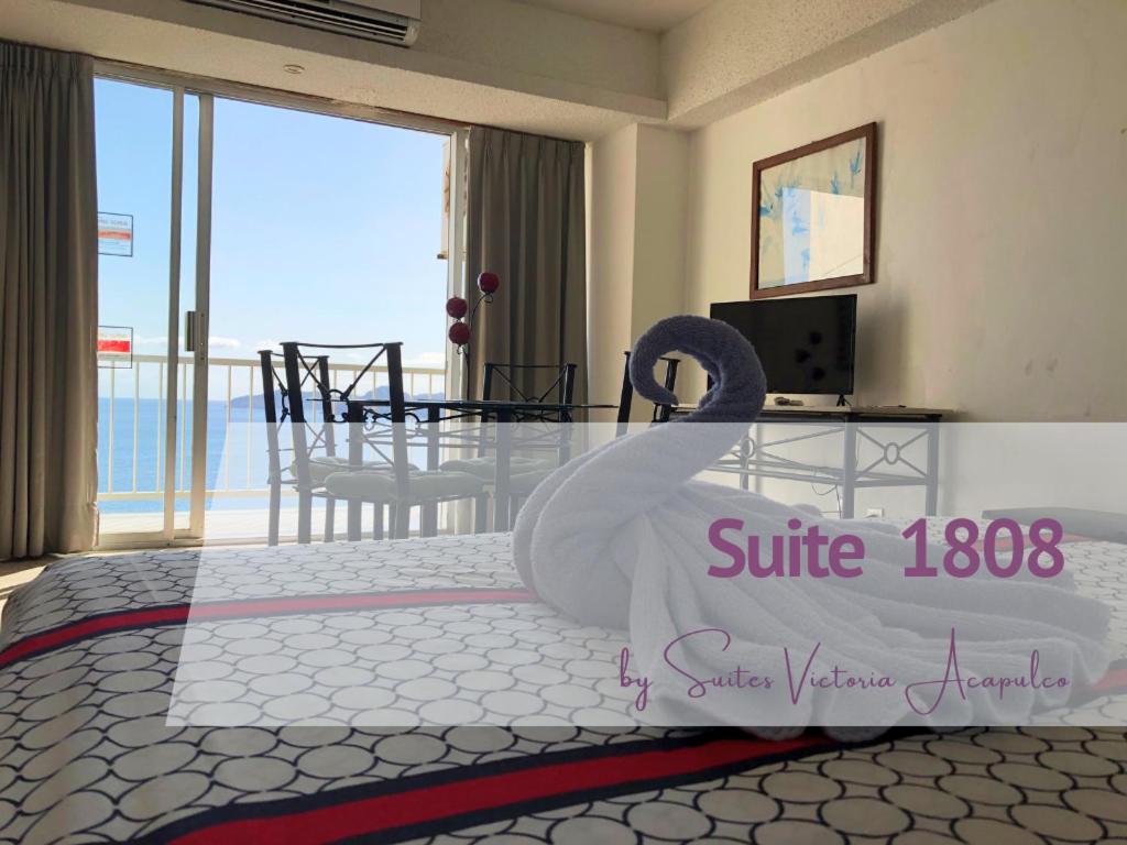 Giường trong phòng chung tại Suite 1808 by Suites Victoria Acapulco