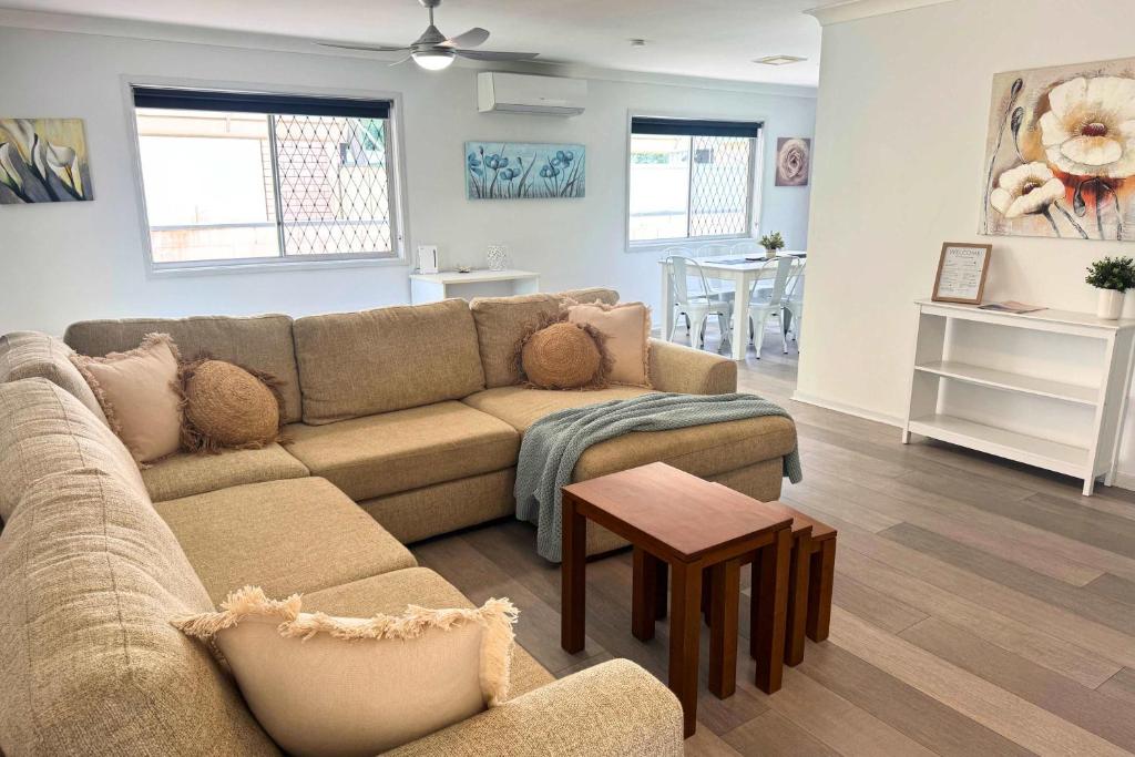 a living room with a couch and a table at Pet Friendly home in Maroochydore in Maroochydore