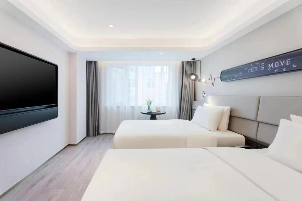 Postel nebo postele na pokoji v ubytování Atour Light Hotel Dalian Xinghai Square Hang Lung Shopping Center