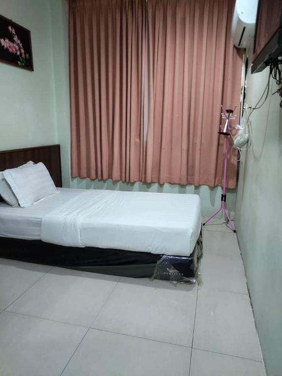 Letto o letti in una camera di T Lodge, Kapit