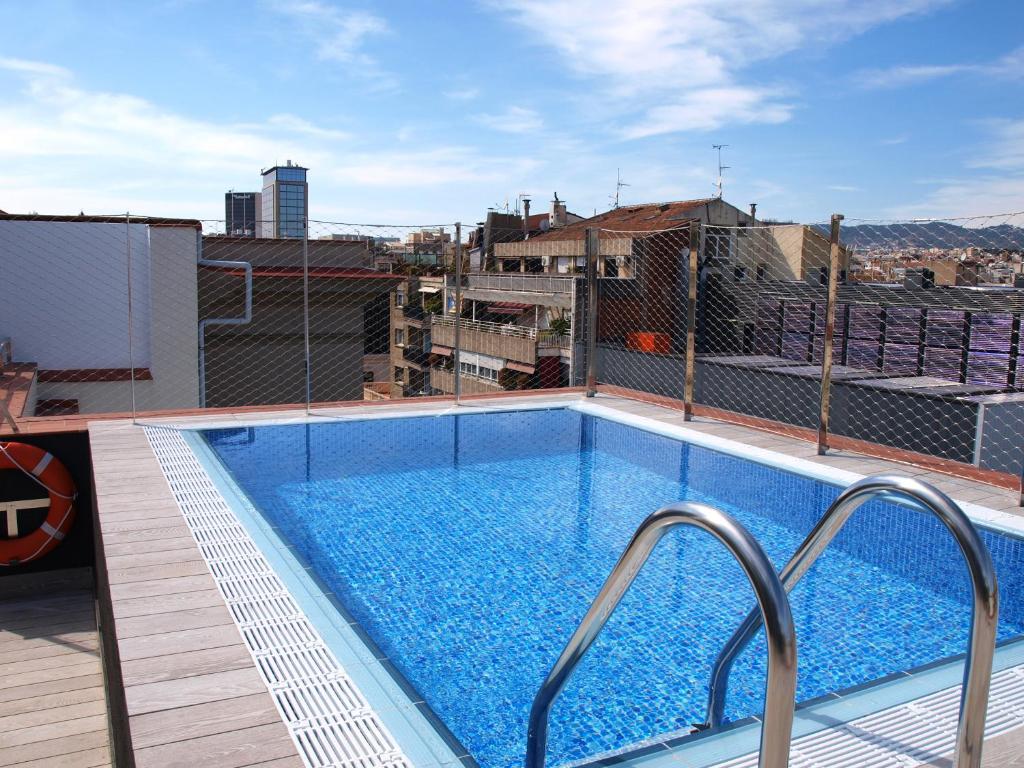 a swimming pool on the roof of a building at Catalonia Gracia in Barcelona