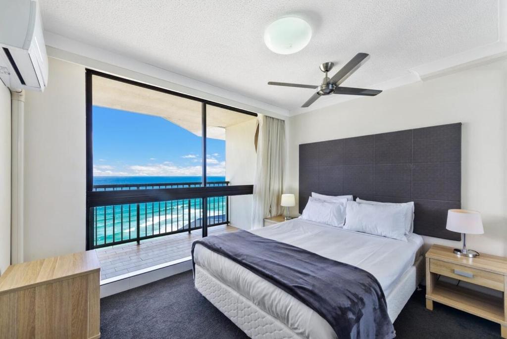 a bedroom with a large bed and a large window at Breathtaking Ocean View 2 BDR Apartment by the Beach in Gold Coast
