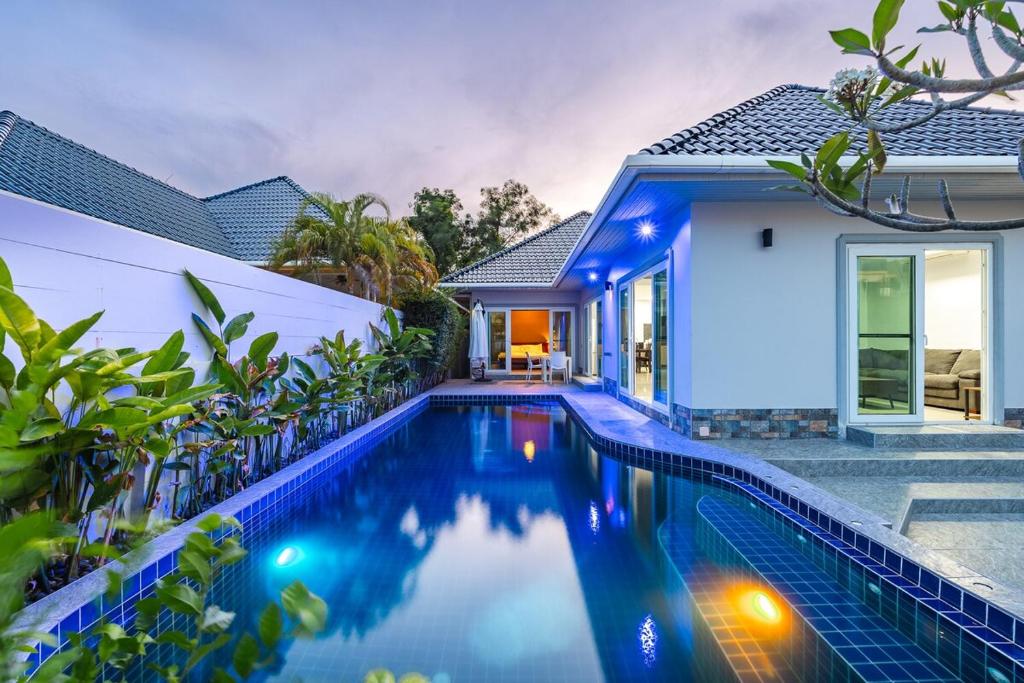 a villa with a swimming pool in front of a house at V174 Great Base 2 Explore Phuket Everting you Need in Phuket Town