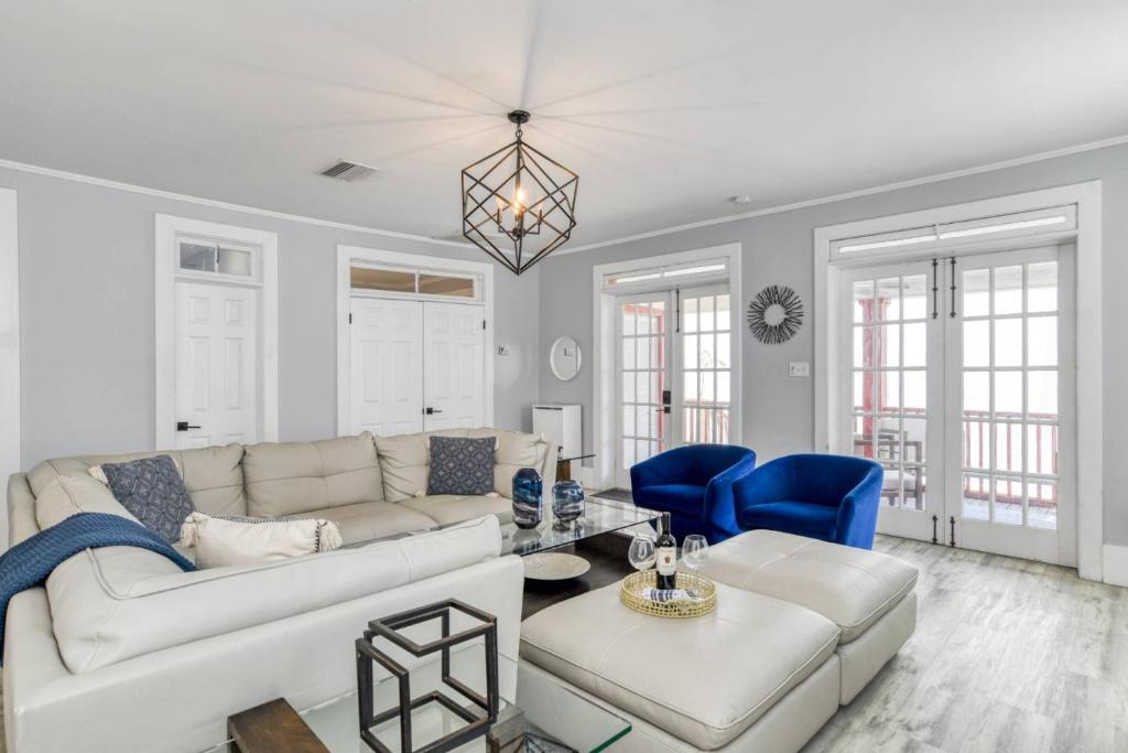 a living room with a white couch and blue chairs at 20 Hypolita Street in St. Augustine