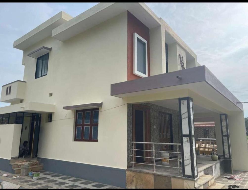 a large white house with a balcony at Holy spirit Arul lobo Peace in Kalyānpur