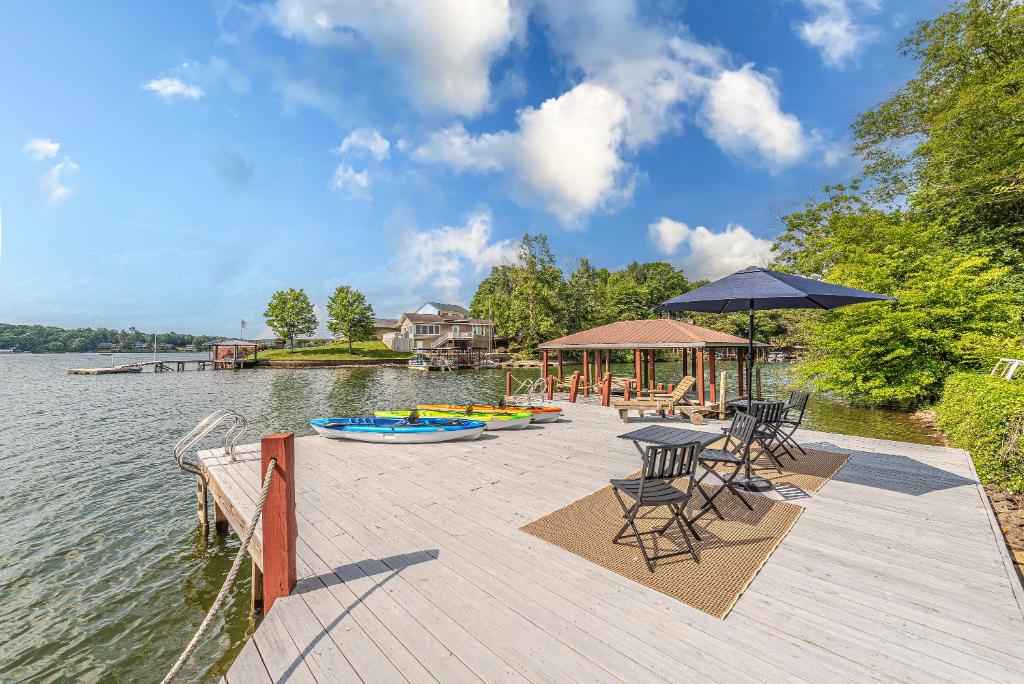 a dock with chairs and tables and a pavilion on the water at Lake Hickory Trio 2BR Green Unit in Hickory