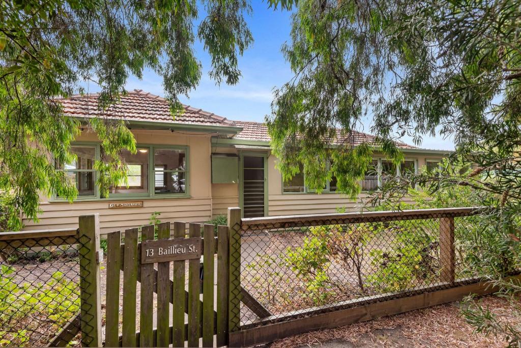 a house with a wooden fence in front of it at Glendarra in Point Lonsdale