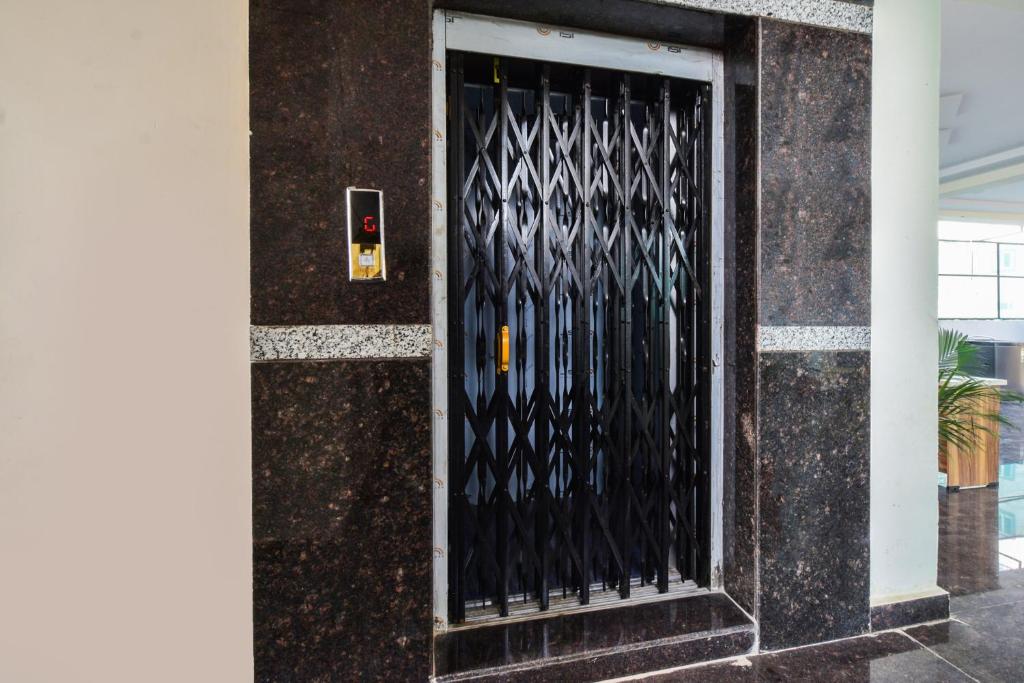 a black door with a metal gate on a building at Super Collection O Adibatla Hyderabad in Ibrāhīmpatan