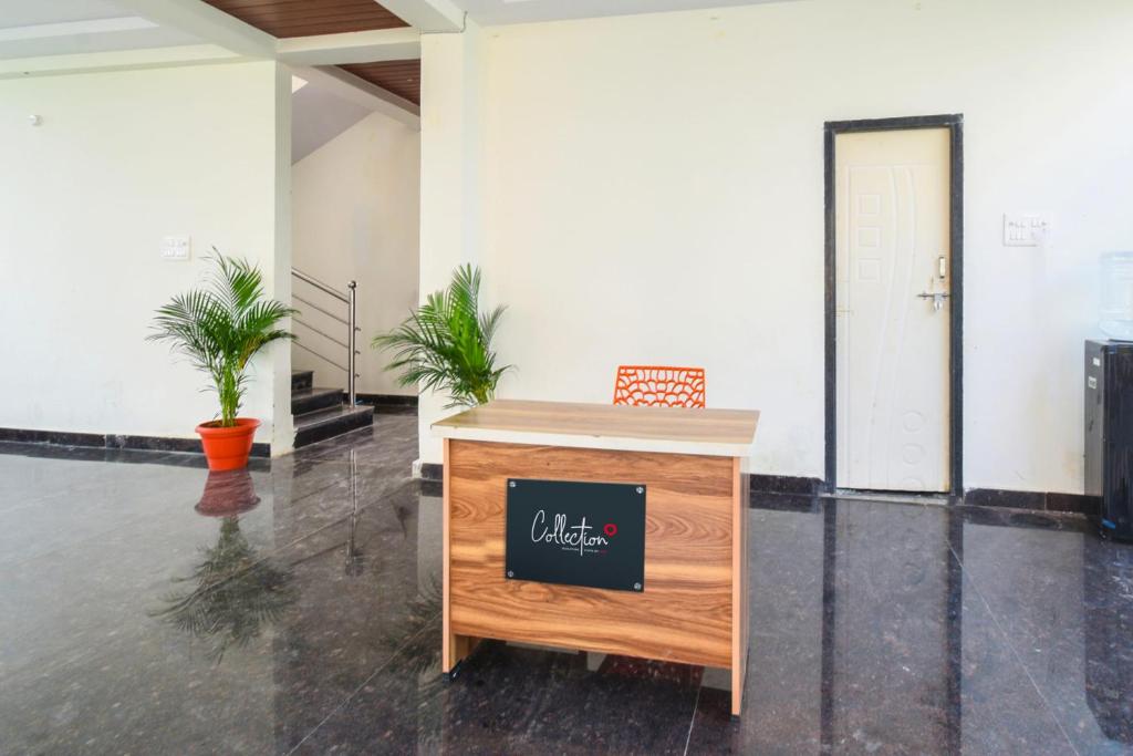 a reception desk in a lobby with a sign on it at Super Collection O Adibatla Hyderabad in Ibrāhīmpatan