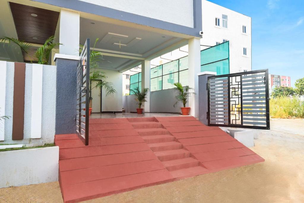 a building with a red walkway in front of it at Super Collection O Adibatla Hyderabad in Ibrāhīmpatan